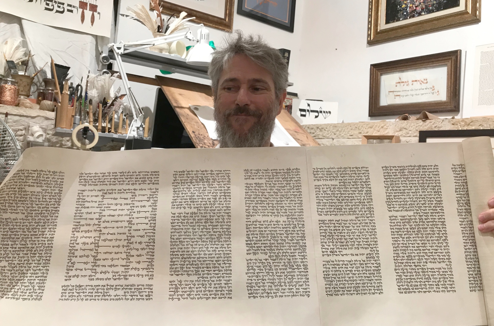 Scribe Jamie Shear showing a Torah scroll he is completing. Photo by Abigail Klein Leichman