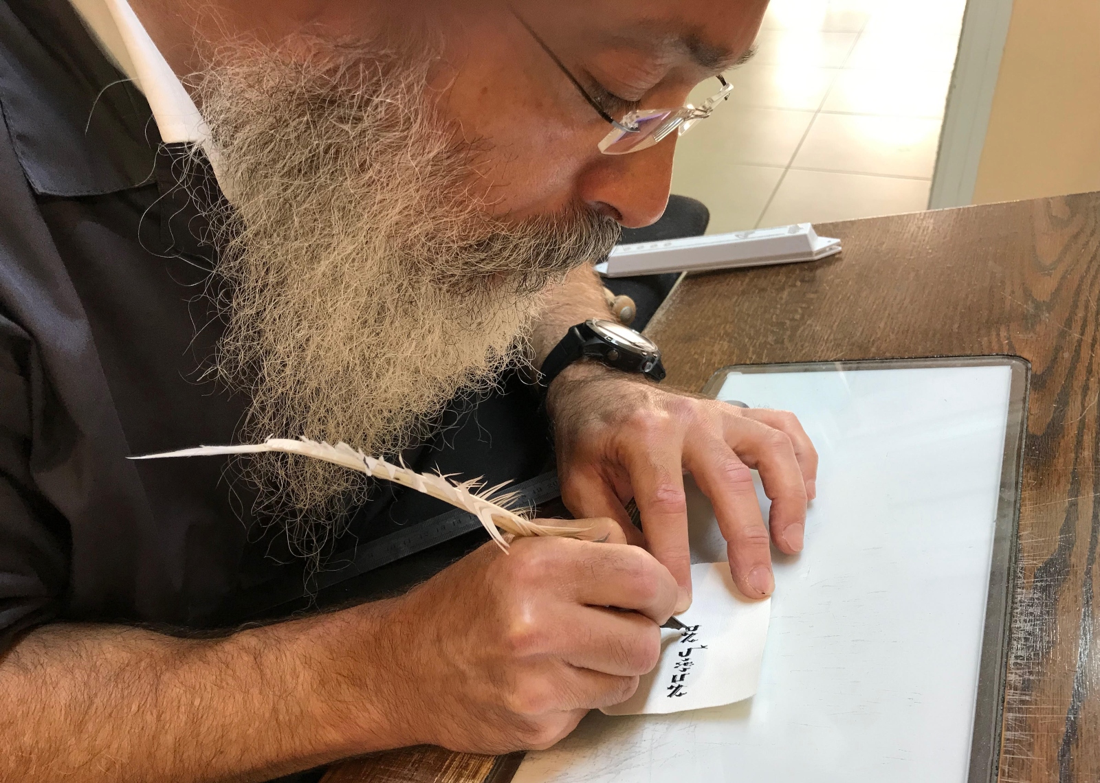 Scribe Gadi Turner at Otzar HaSTAM in Safed writing “Abigail” in Hebrew on a parchment. Photo by Abigail Klein Leichman