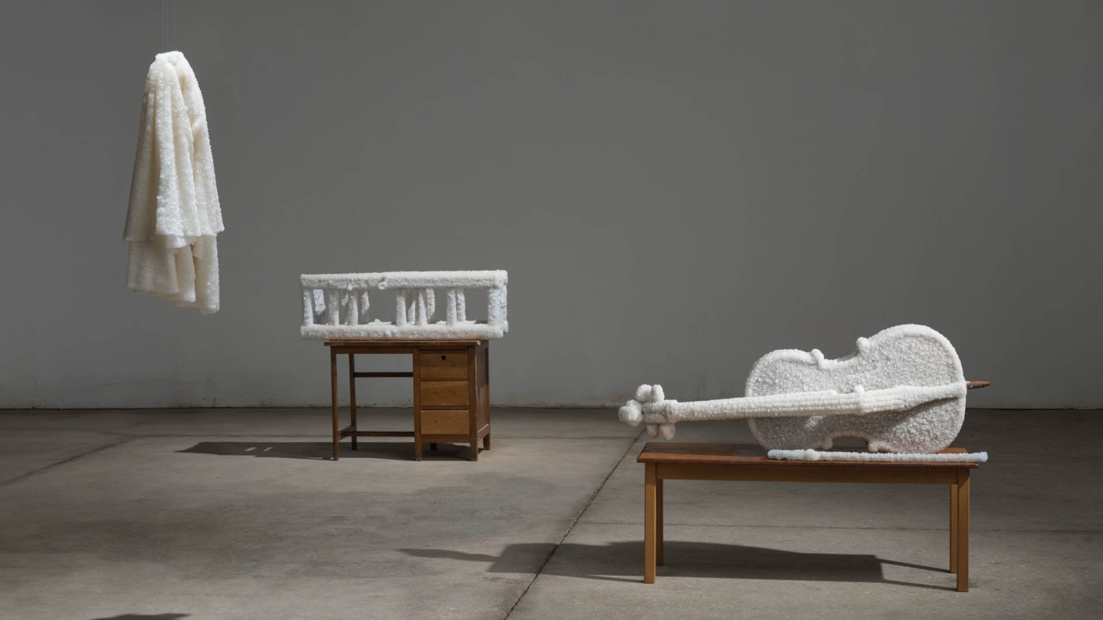 “When I Go, 2017” -- readymade objects (double-sided stool, cello, bow, woodenstool, bridal veil) coated in salt crystals, on readymadefurniture, studio installation views. Photo by Yotam From, ©Sigalit Landau, 2019