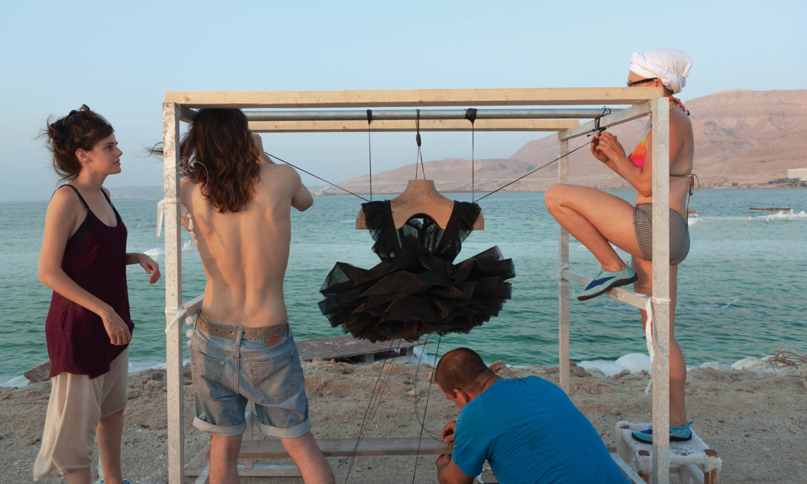 Preparations to lower a black tutu into the Dead Sea, 2016. Photo by Shaxaf Haber, ©Sigalit Landau, 2019