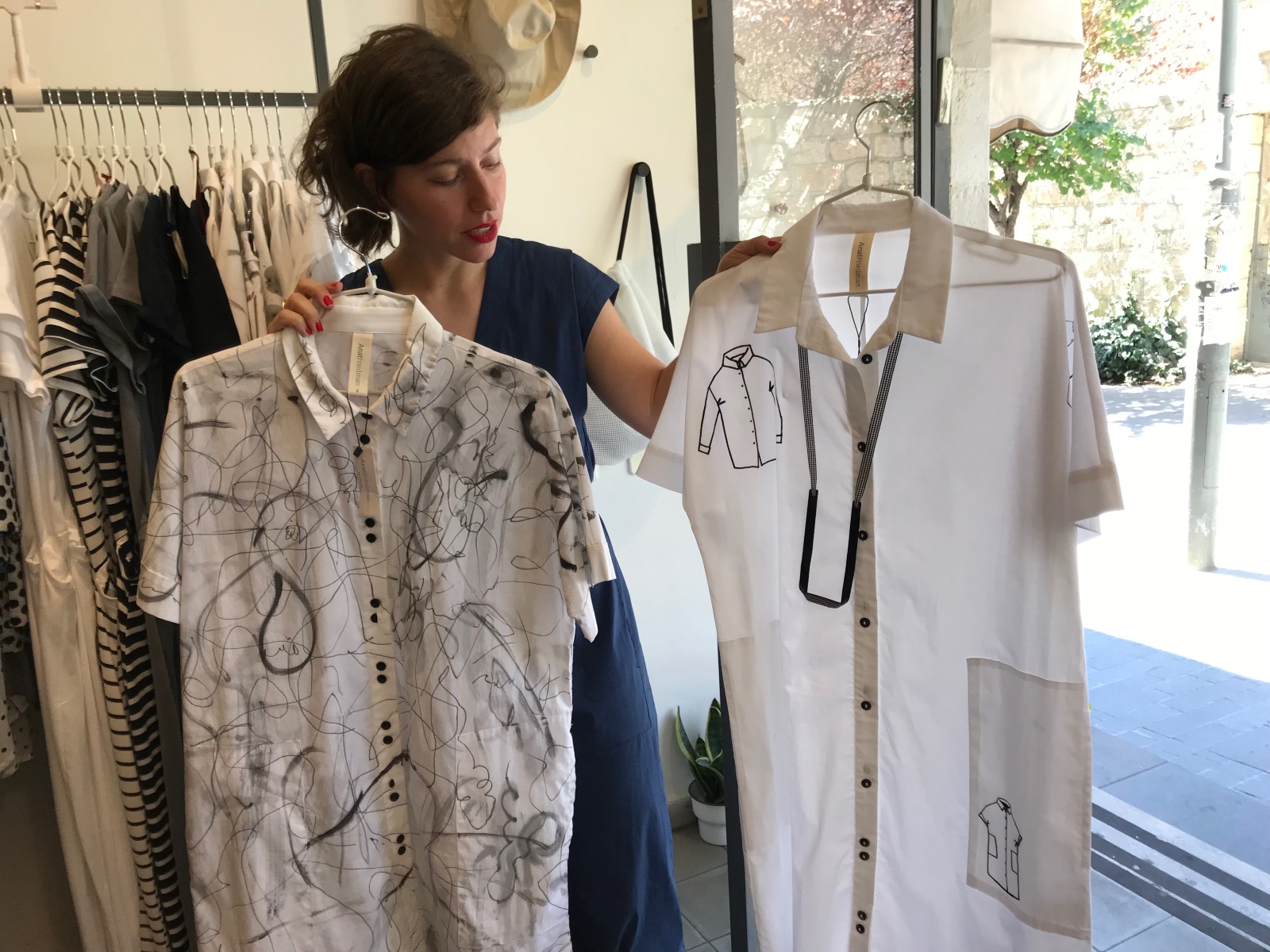 Anat Friedman with two of her hand-painted dresses. Photo by Abigail Klein Leichman