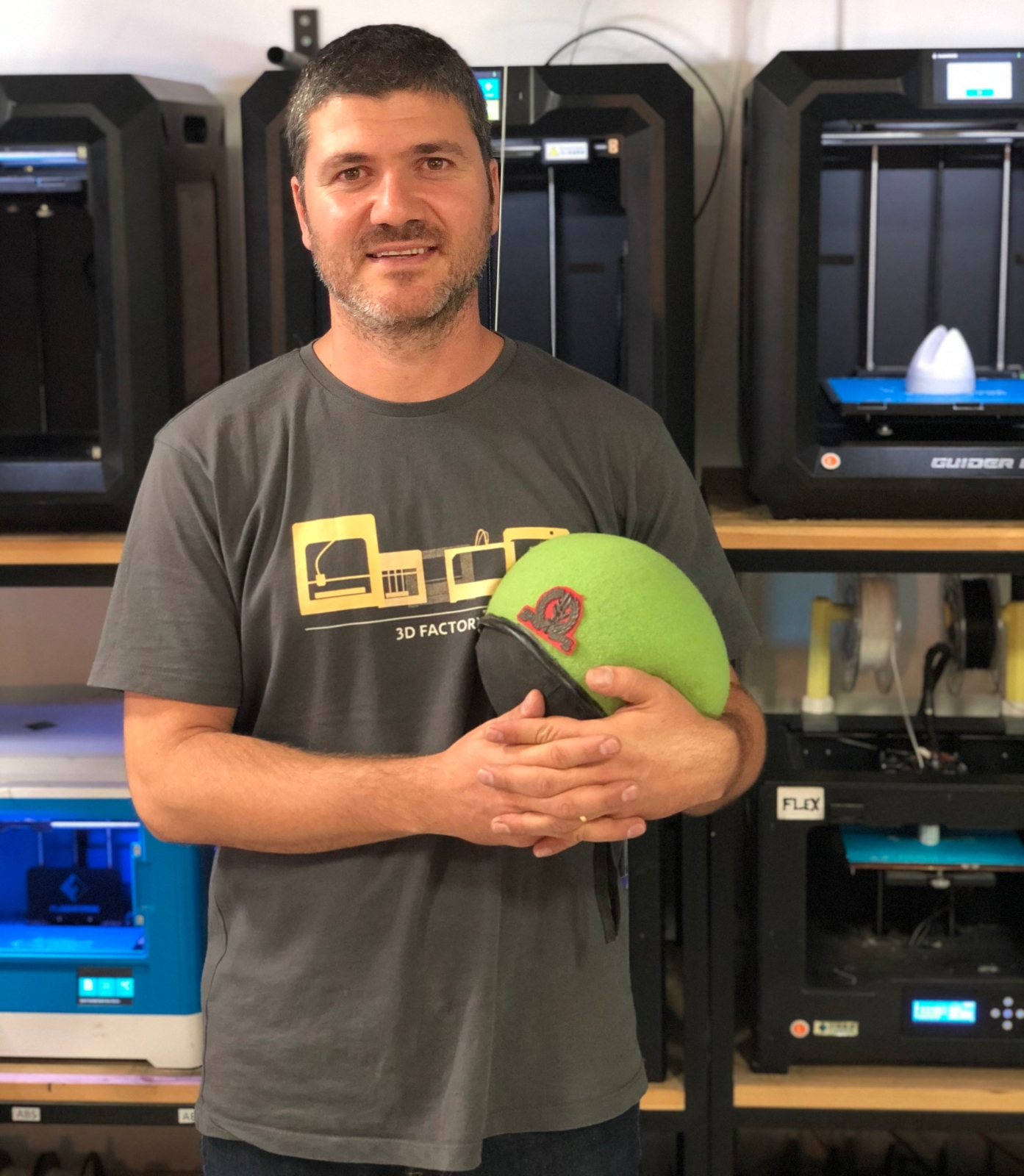 Industrial Designer Shaul Cohen with his playful inflatable army beret/pillow. Photo by Niv Yulevitch