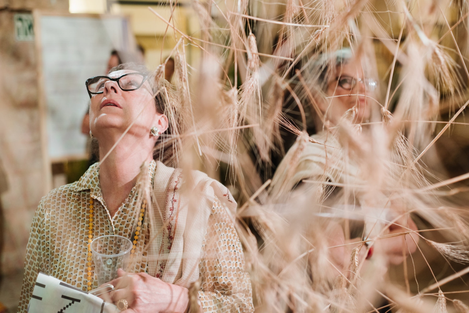 Visitors walking through the “wheat” at Hansen House, Jerusalem. Photo by Dor Kedmi