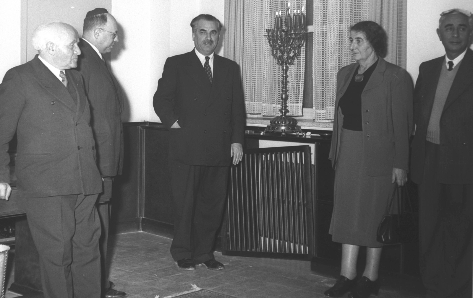 Members of the Second Knesset light candles on the sixth night of Hanukkah in 1952. From left, David Ben-Gurion, Yosef Burg, Haim-Moshe Shapira, Golda Meir, Pinhas Lavon. Photo: GPO