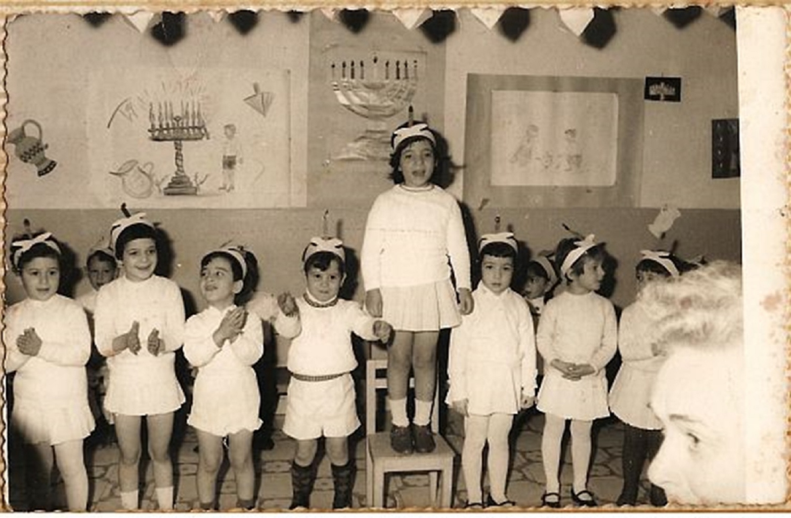 A 1966 kindergarten class in Haifa wearing candle headdresses to play the part of a Hanukkah menorah. Photo by OlySela/Nostalgia Online