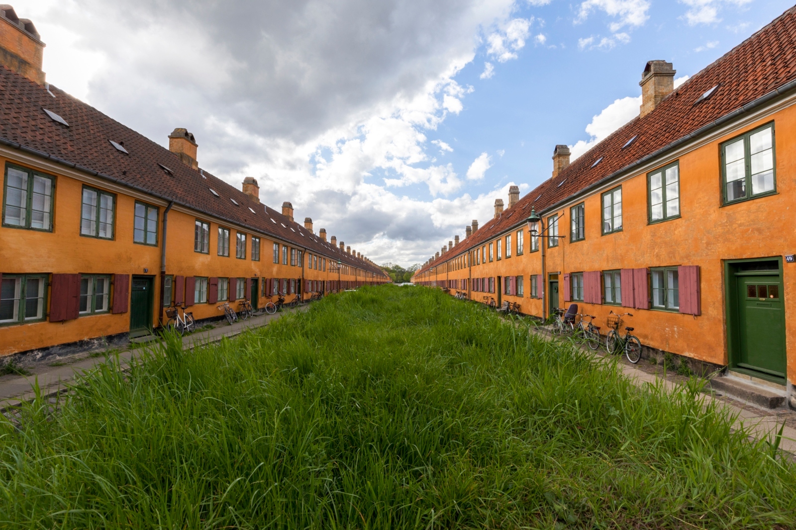 Orange row houses across the Nyboder neighborhood in Copenhagen, Denmark, were built in the 18th century to house sailors of the Royal Danish Navy and their families. Photo by Ilan Rogers