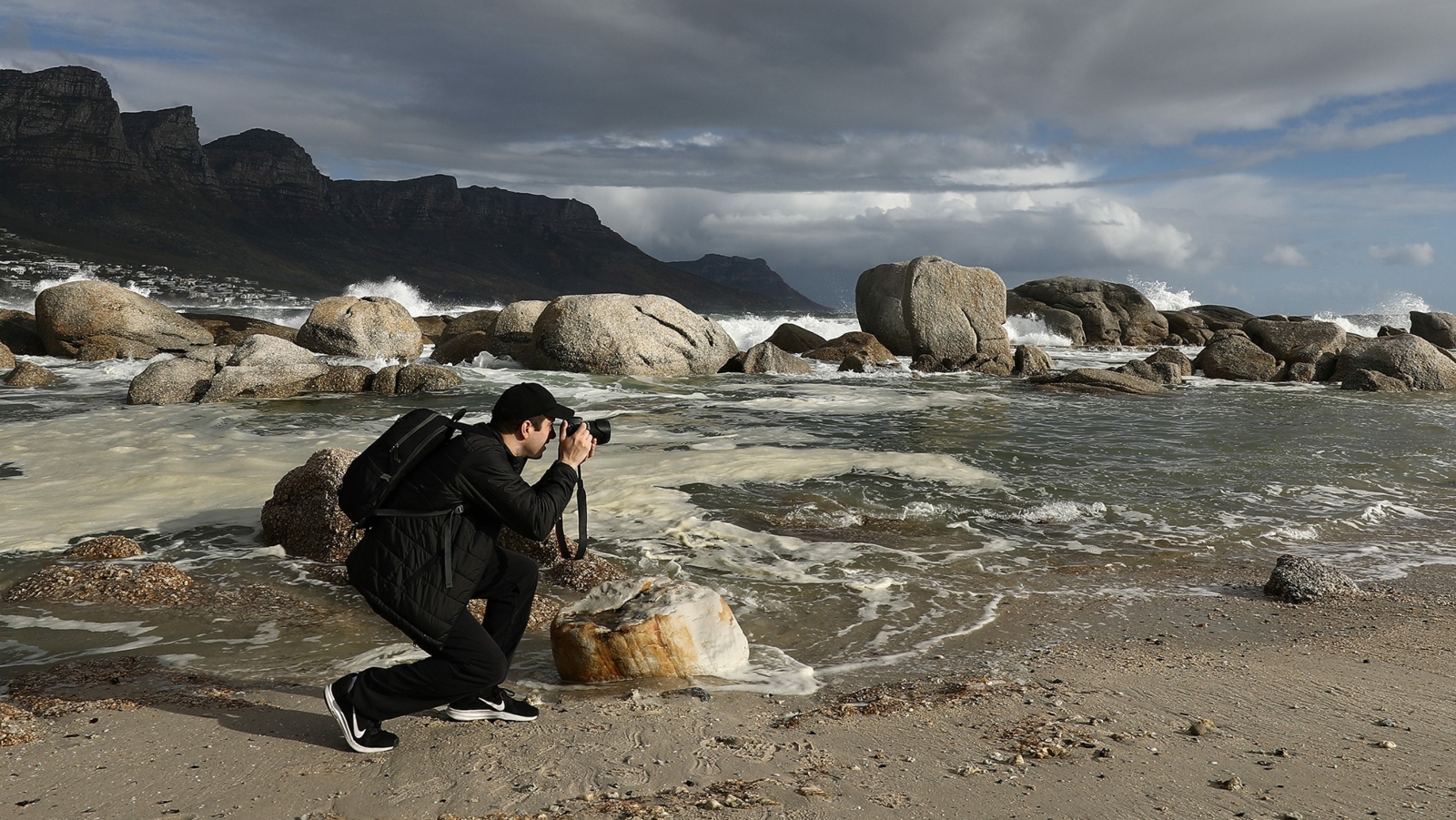 Ilan Rogers photographing on a beach in Cape Town, South Africa.
