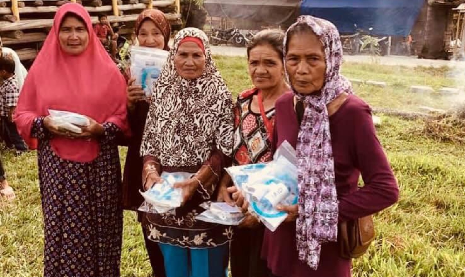 Women in Indonesia receiving small family clean water units from SmartAID. Photo: courtesy