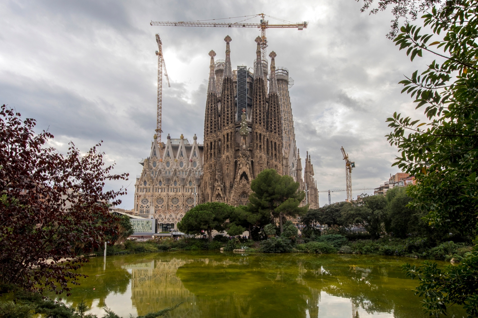 The Sagrada Familia basilica in Barcelona reflects into a green lake behind it. The famous church is nearing completion after more than 130 years. Photo by Ilan Rogers