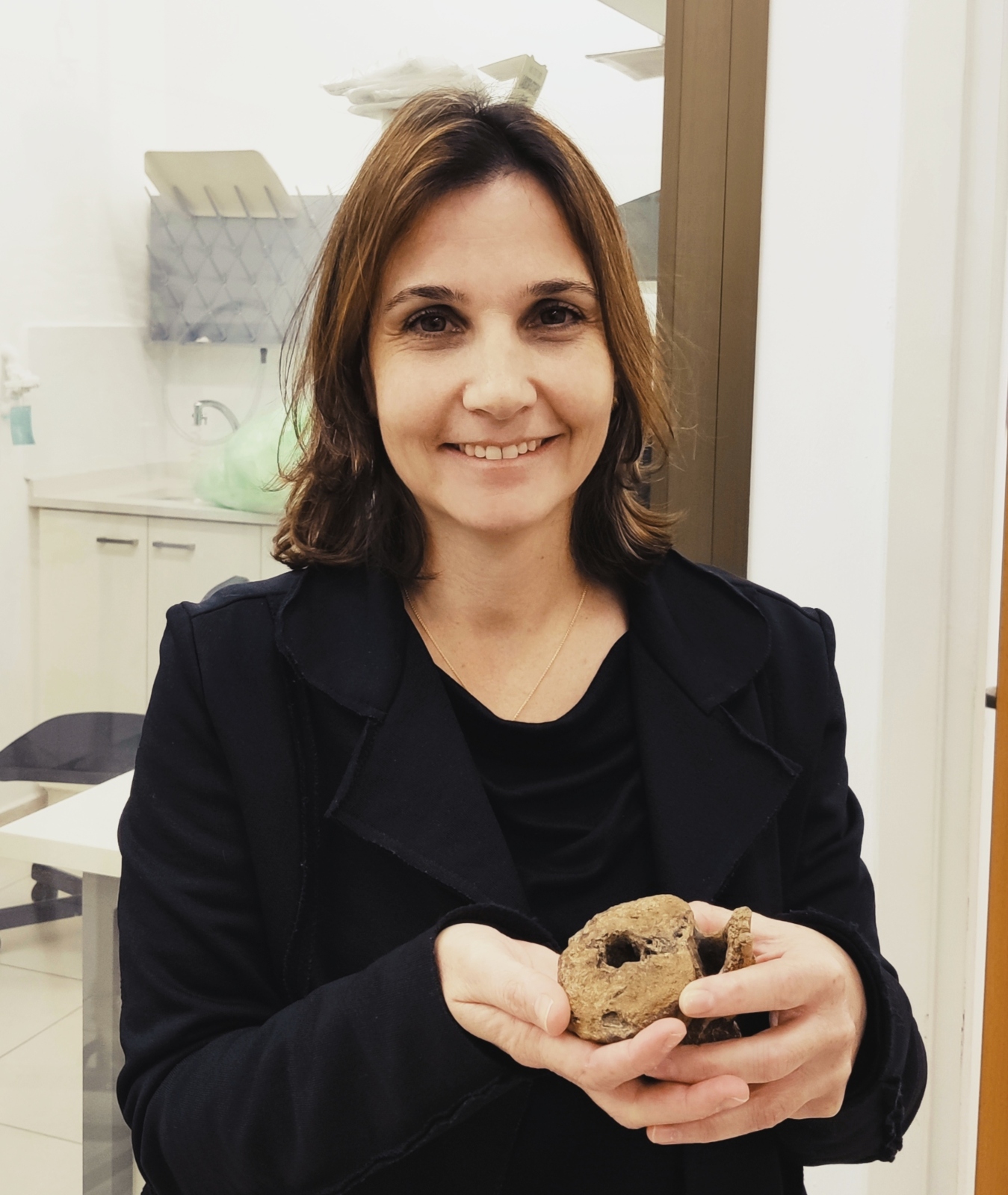 Dr. Hila May holding a hadrosaur vertebra. Photo courtesy of Tel Aviv University