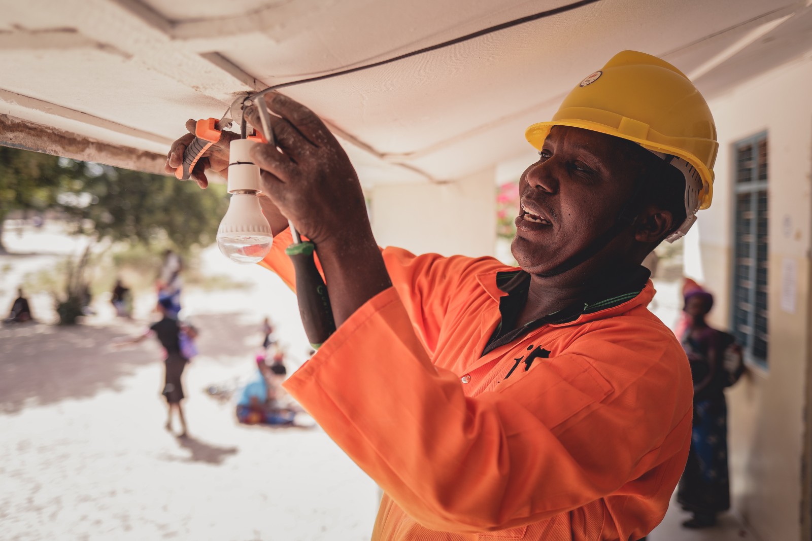 An Innovation: Africa technician installing a light bulb. Photo: courtesy