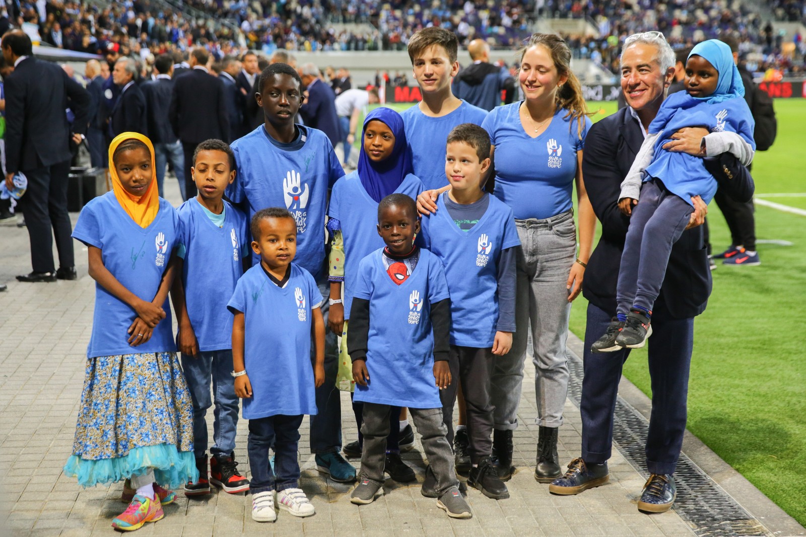 Sylvan Adams with children who owe their lives to Save a Child’s Heart, at the Argentina-Uruguay friendly soccer game at Bloomfield Stadium in Tel Aviv, November 18, 2019. Photo by FLASH90