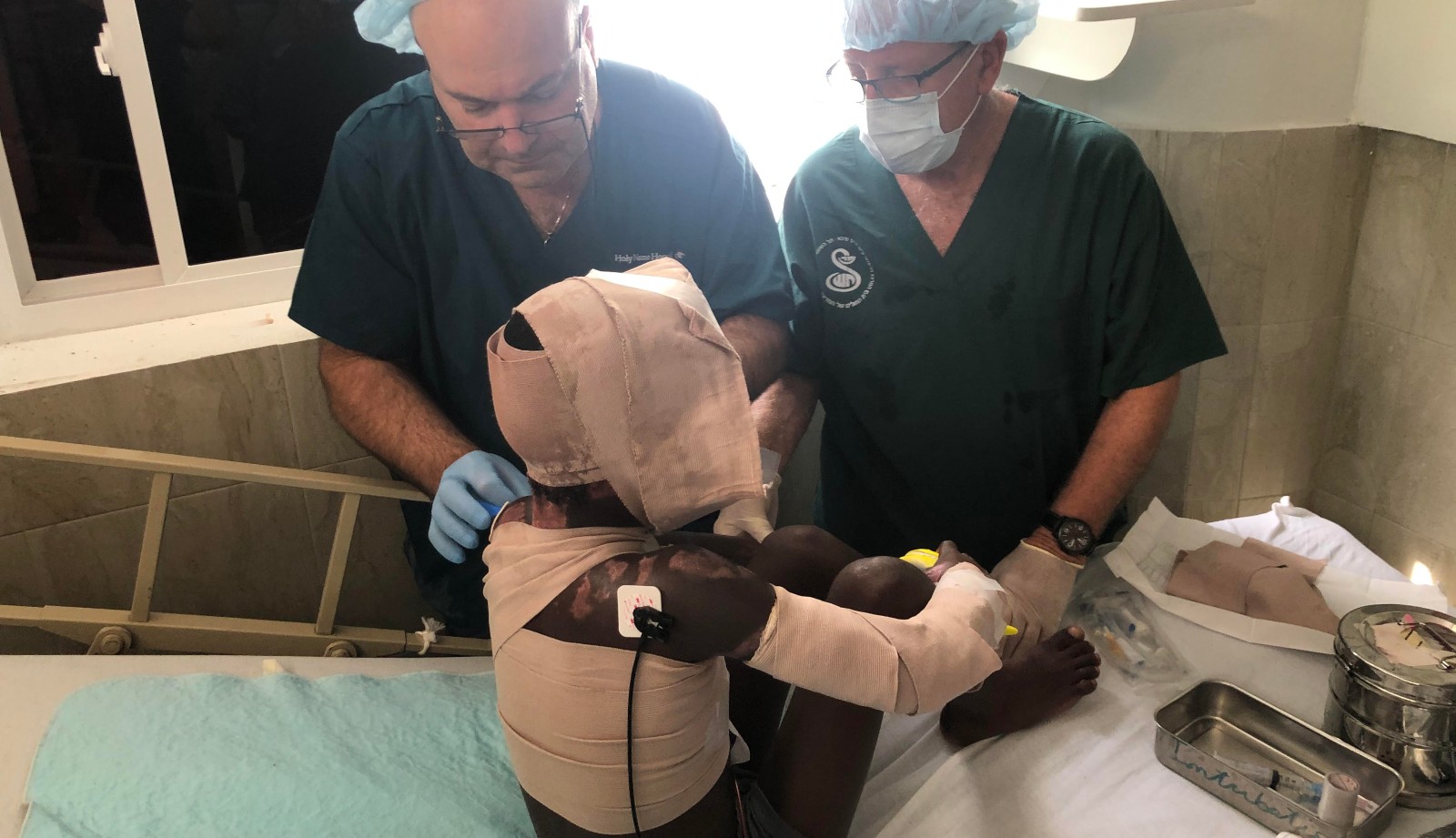 Dr. Elhanan Bar-On, director of Sheba Medical Center's Israel Center for Disaster Medicine and Humanitarian Response, and a colleague treating a patient in Haiti. Photo: courtesy