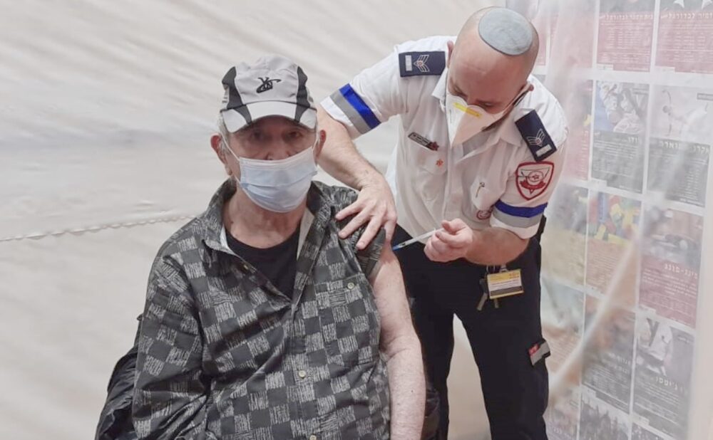 An EMT administers a Covid-19 vaccination to a resident of an elder facility in Karnei Shomron. Photo courtesy of Magen David Adom Spokesman’s Office