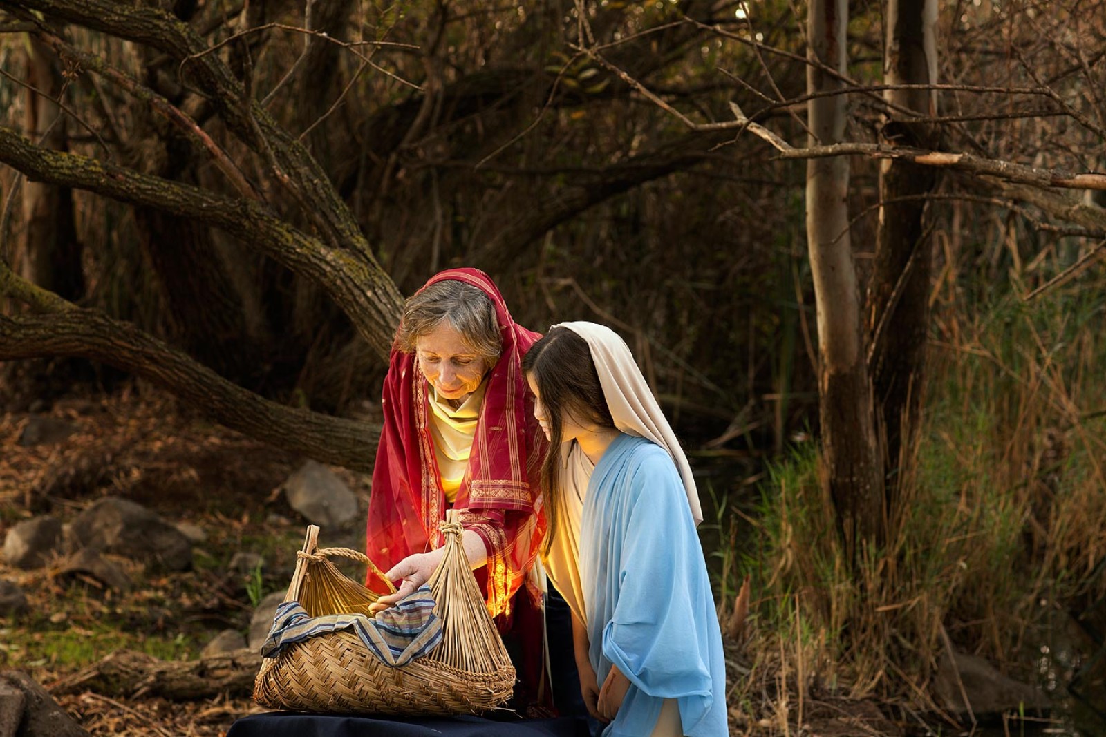 Jocheved and Miriam place baby Moses in a basket. Photo © Dikla Laor