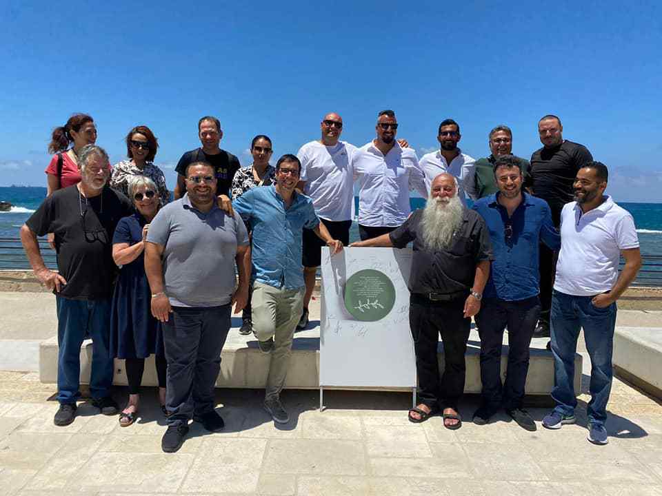 Uri Jeremias (bottom, third from right) with Muslim, Jewish and Christian restaurant owners meeting on May 18, 2021 on the burned terrace of his Uri Buri restaurant in Acre. Photo courtesy of Uri Jeremias