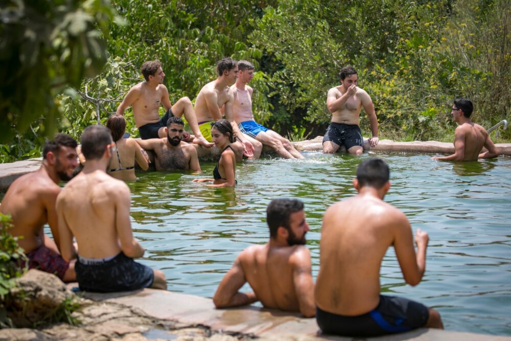 People enjoy a hot summer evening at the Ein Lavan Spring in Jerusalem, July 27, 2020. Photo by Olivier Fitoussil/Flash90