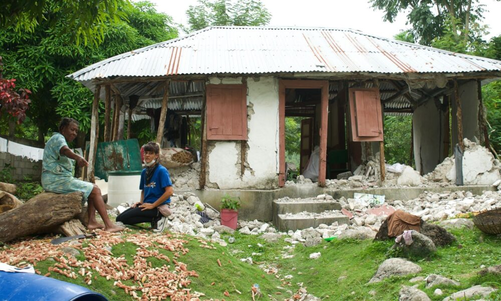 IsraAID Haiti Head of Mission Dana Yaari surveying a house destroyed in the August 2021 earthquake. Photo courtesy of IsraAID