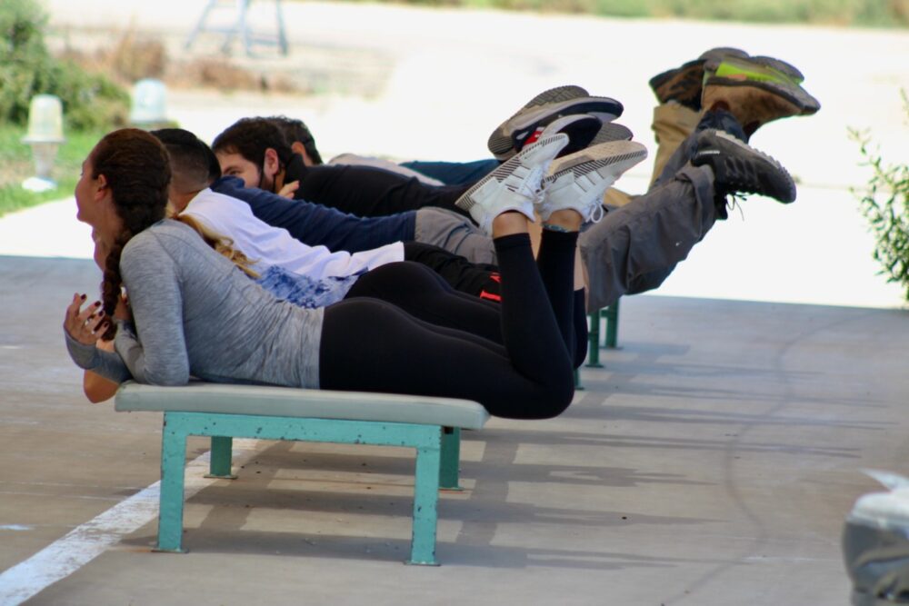 A Paradive instructor showing Brian Blum’s group how to position their limbs during the freefall and landing. Photo by Merav Blum