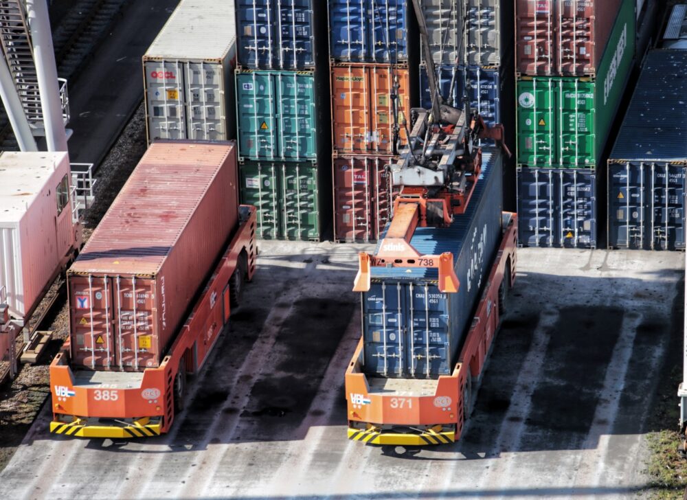 Container loading in Rotterdam’s port. Photo by Bernd Dittrich on Unsplash