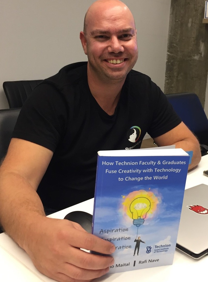 Ran Korber holding the Technion’s centennial book in which he is highlighted. Photo by Diana Bletter