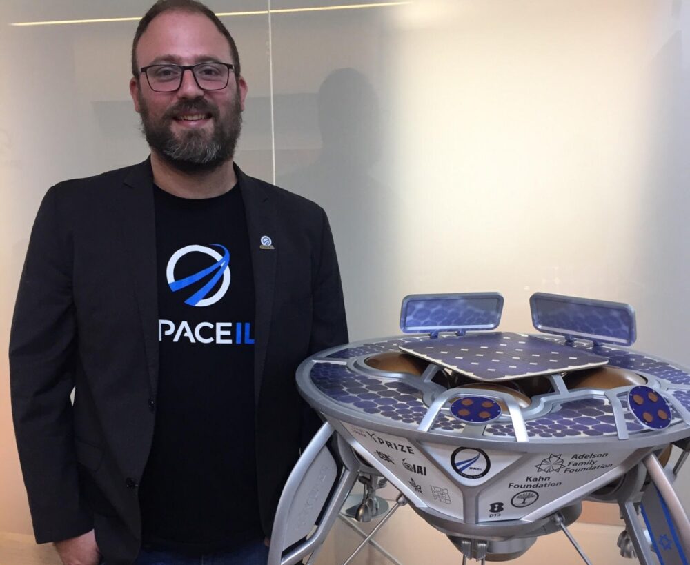 Kfir Damari next to a model of Beresheet 1. Photo by Diana Bletter