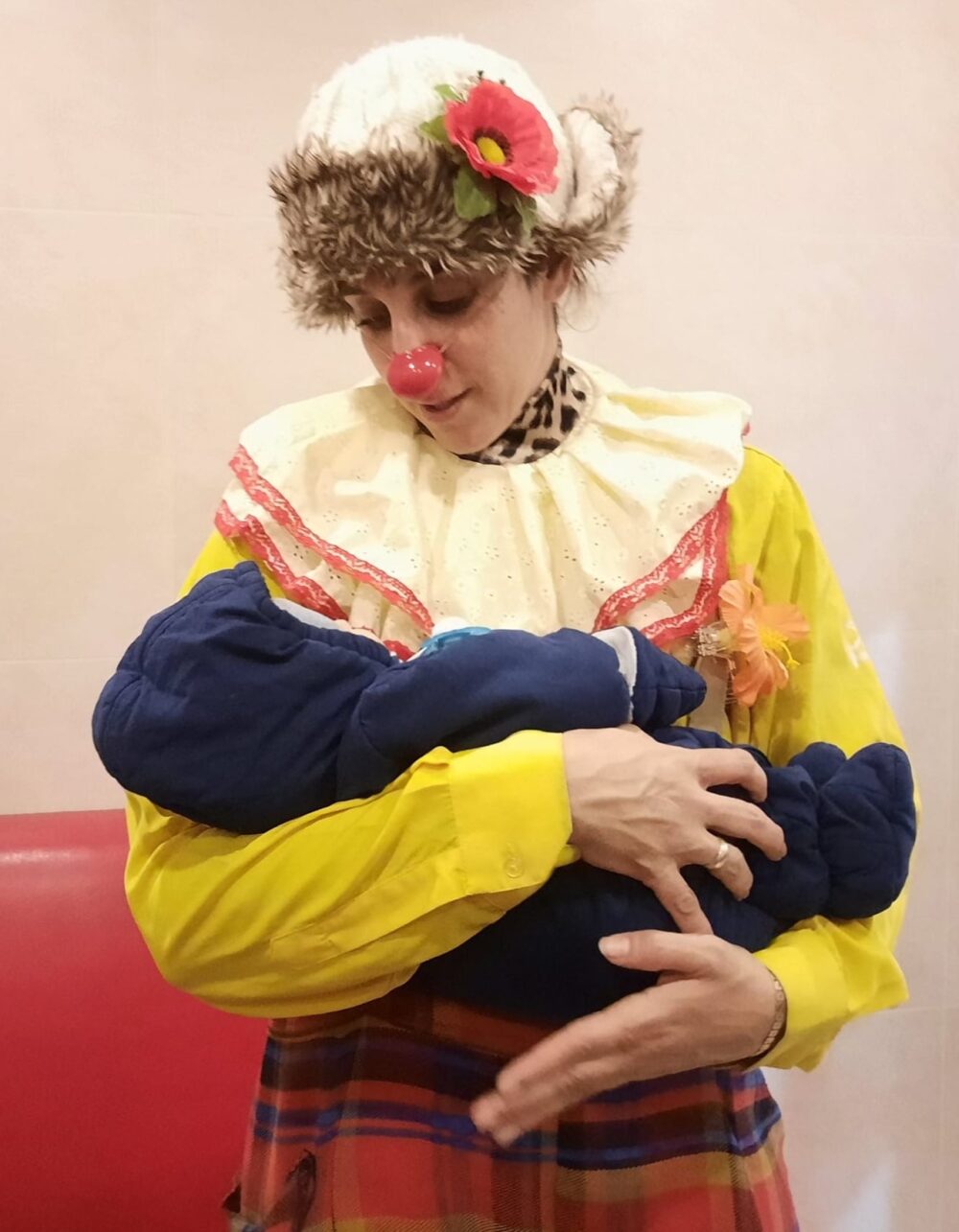 Reut Shifman Tsoref, aka Zaza the Dream Doctor, holding a month-old baby in a Moldovan shelter for Ukrainian refugees. Photo courtesy of Zaza