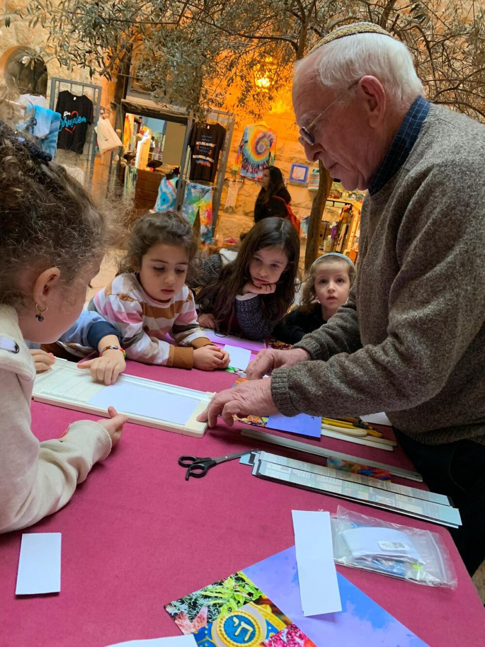 A papercrafts and bookmark workshop with artist Abba Richman at ImagiNationz. Photo by Tova Hametz