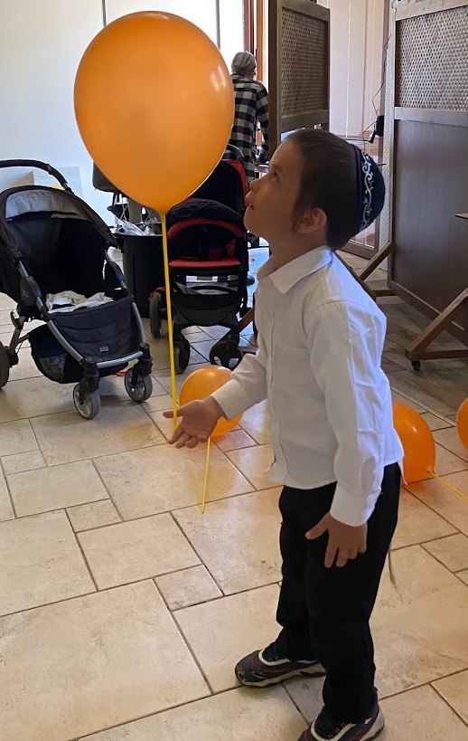 One of the younger Ukrainian children at Nes Harim plays with a balloon. Photo by Nicky Blackburn