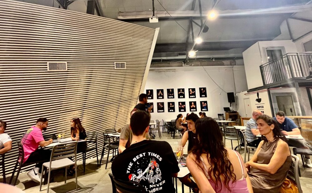 BlackOut diners place orders in the lighted lobby before entering the self-contained dining area, shown here to the left. Photo by Samantha Baron