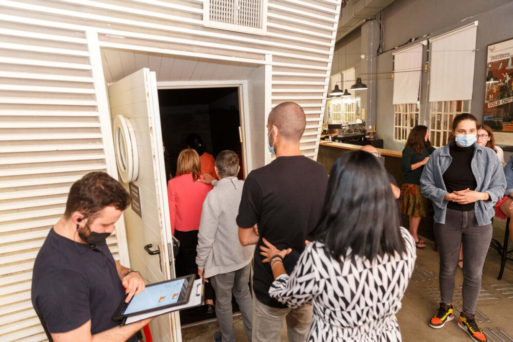 Diners at BlackOut form a conga line to stay in contact as they enter the dark restaurant. Photo courtesy of NaLaga’at