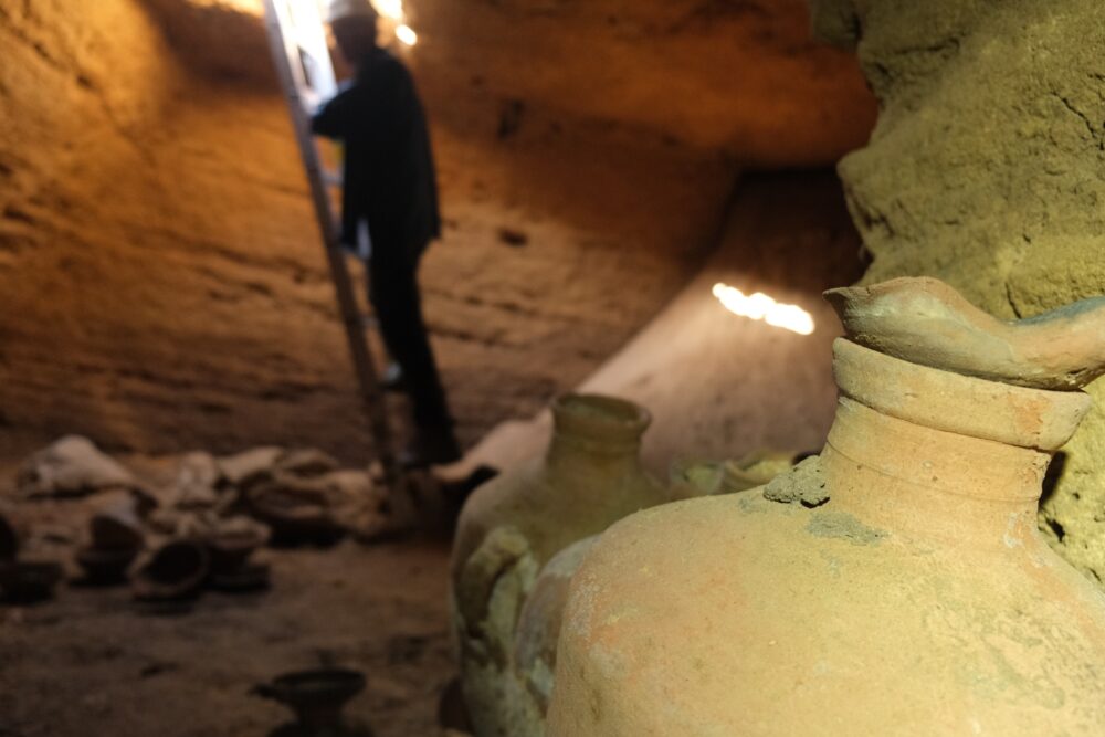 Climbing into the newly discovered burial cave. Photo by Emil Aladjem/Israel Antiquities Authority