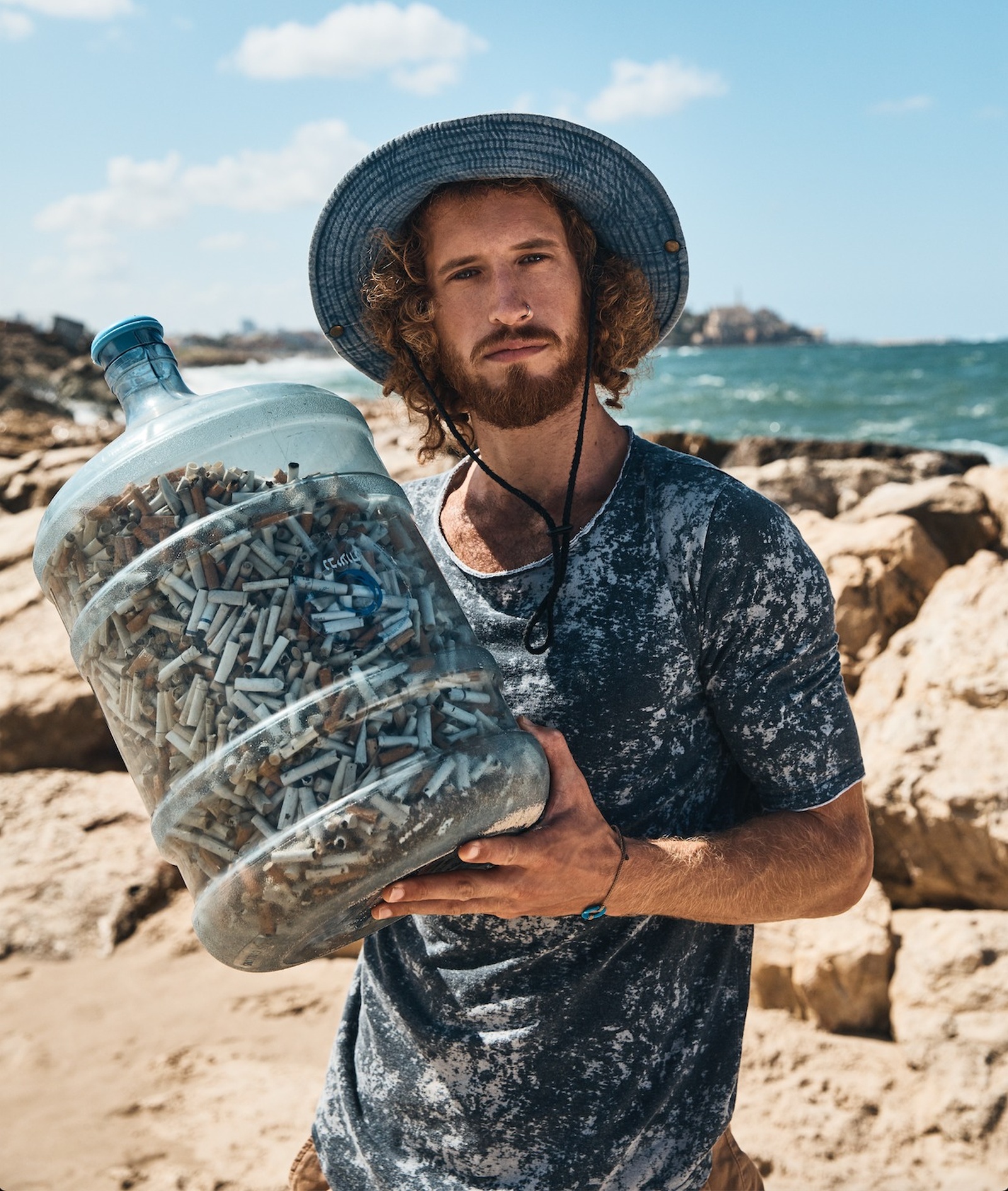 Julian Melcer with cigarette butts collected from Israel’s parks and beaches. Photo by Yossi Michaeli