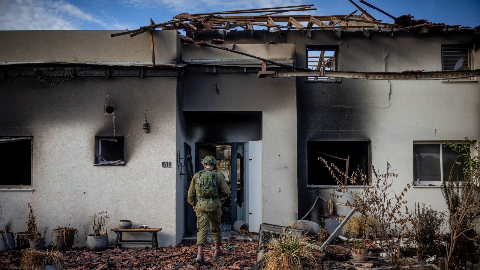 Israeli soldiers contemplate the destruction caused by Hamas in Kibbutz Be'eri, near the Israeli-Gaza border, October 17, 2023. Photo by Yonatan Sindel/Flash90