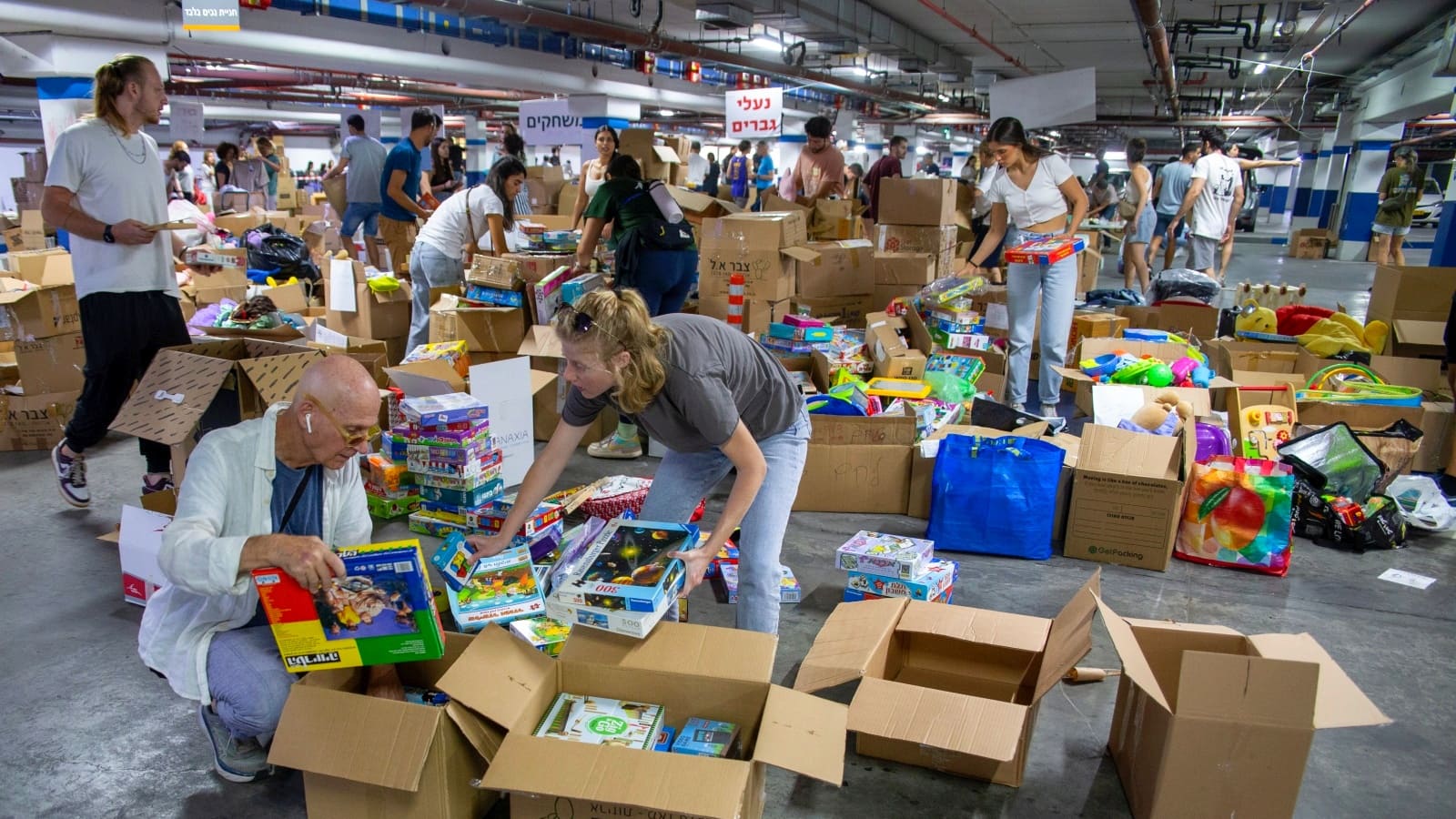 Eran’s Angels packing donations at a parking garage in Tel Aviv. Photo by John Jeffay