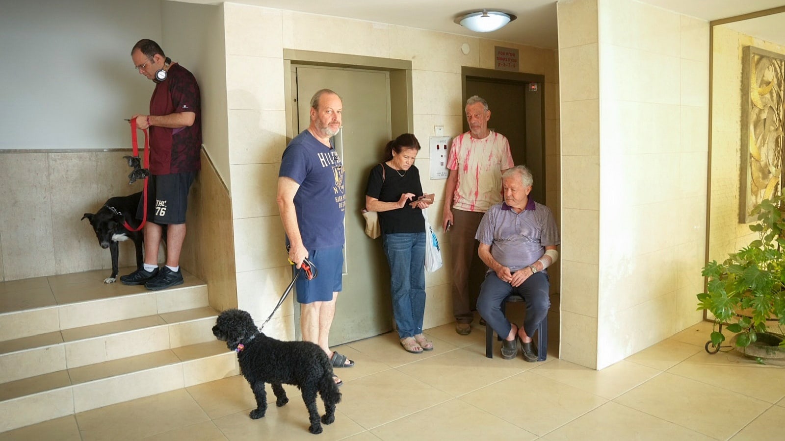 People take cover in a stairway in Tel Aviv, as a red alert is sounded, when a rocket barrage is fired from Gaza, October 7, 2023. Photo by Erik Marmor/Flash90