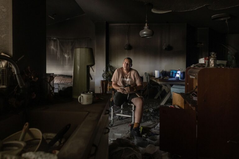 Avida Bachar sits among the ruins of his home in Kibbutz Be’eri, where he lost his leg and where his wife and son were murdered. Avishag Shaar-Yashuv for The New York Times