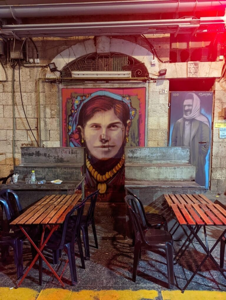 This market stall in Machane Yehuda’s Agas (Pear) Street now sports portraits of the original house’s owners, Bachora and Meir Banai. Photo by Solomon Souza