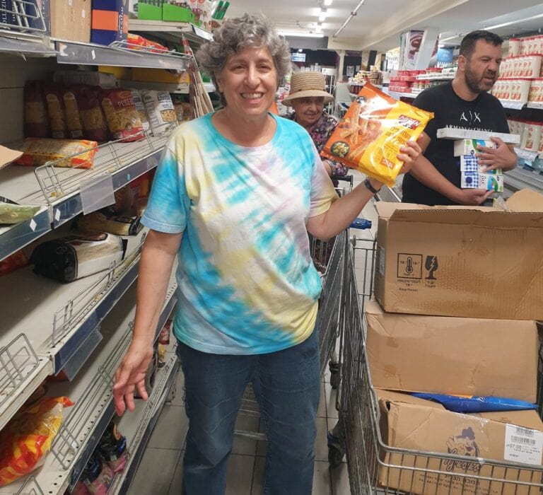 Tour guide Susie Ben David stocking shelves at her local supermarket in November. Photo courtesy of Susie Ben David