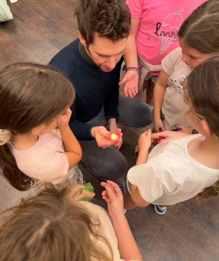 Ophir Samson giving magic lessons to Israeli refugees in an evacuation hotel. Photo courtesy of Ophir Samson