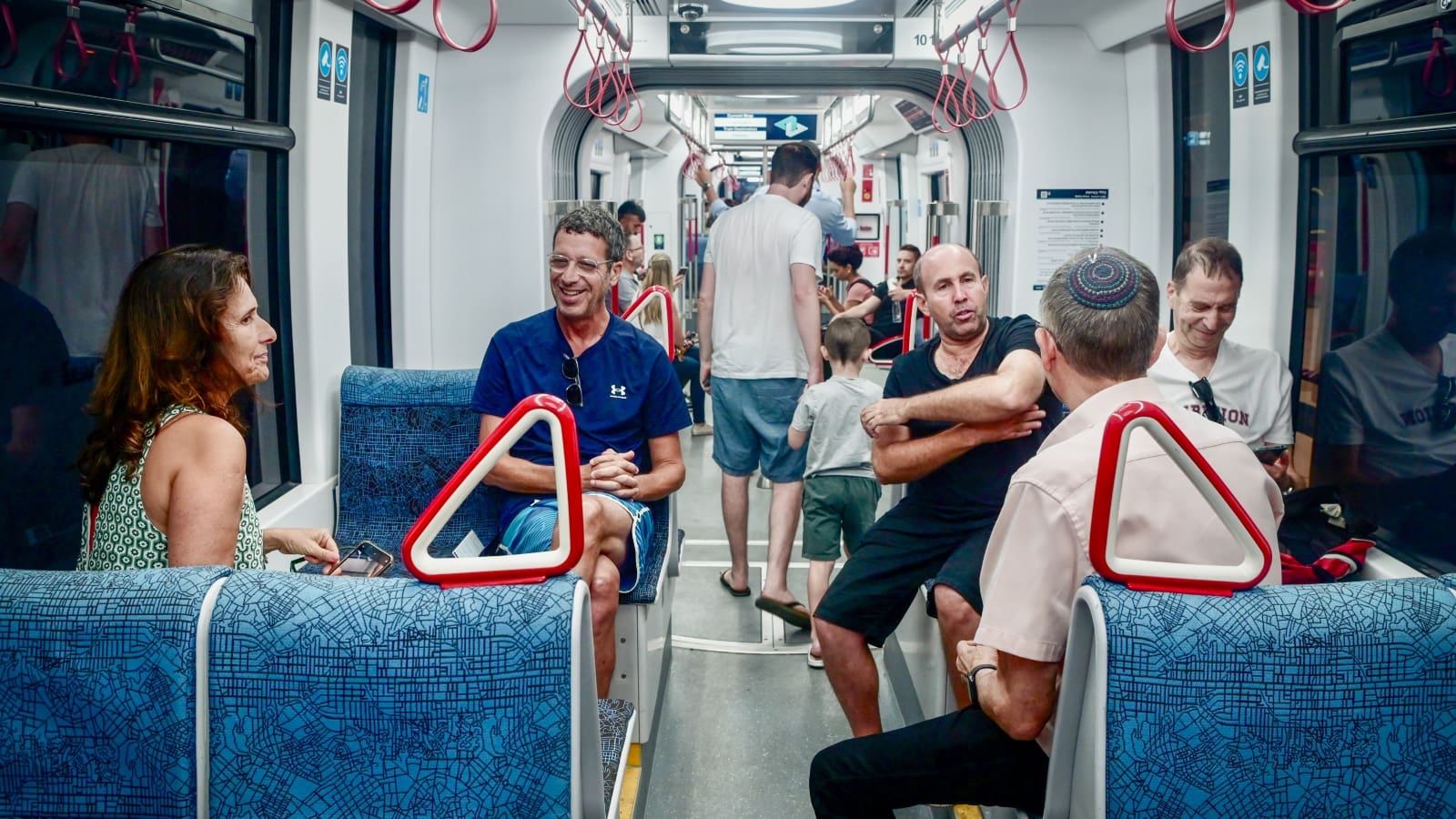 Passengers on Tel Aviv’s Metropolitan Light Rail chatting with each other. Photo by Avshalom Sassoni/Flash90