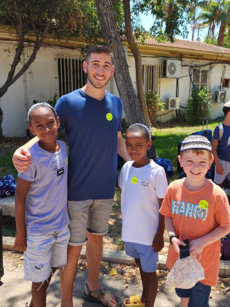 A Camp Koby counselor with campers who lost family members to terror. Photo courtesy of Koby Mandell Foundation