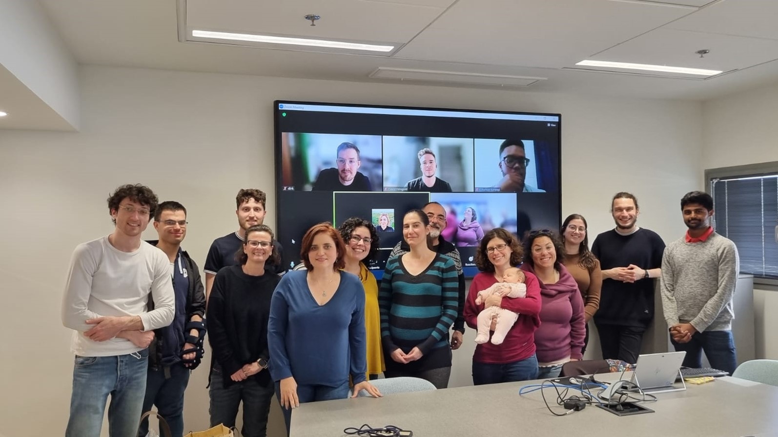 Assistant Prof. Anna Zamansky, in blue v-neck sweater, with her lab team. Photo courtesy of Tech4Animals Lab/University of Haifa