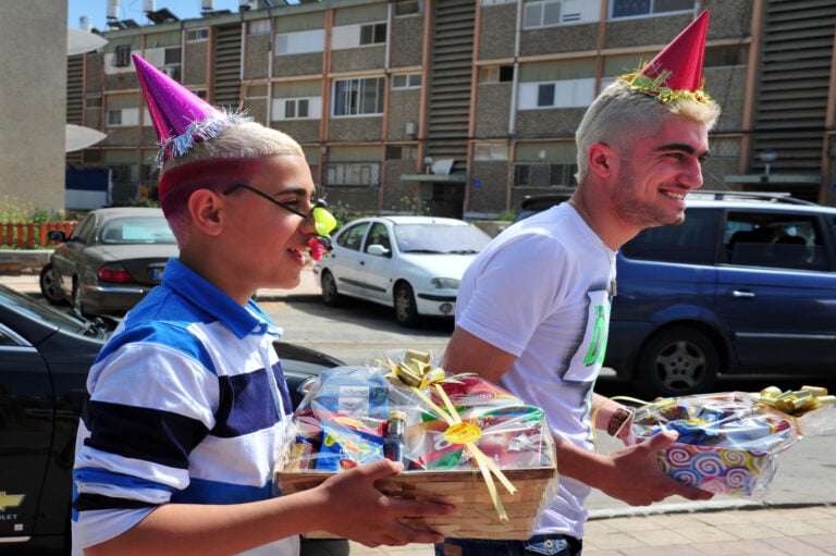 Mishloach manot, festive food packages, are shared with friends and neighbors on Purim. Photo by ChameleonsEye via Shutterstock.com