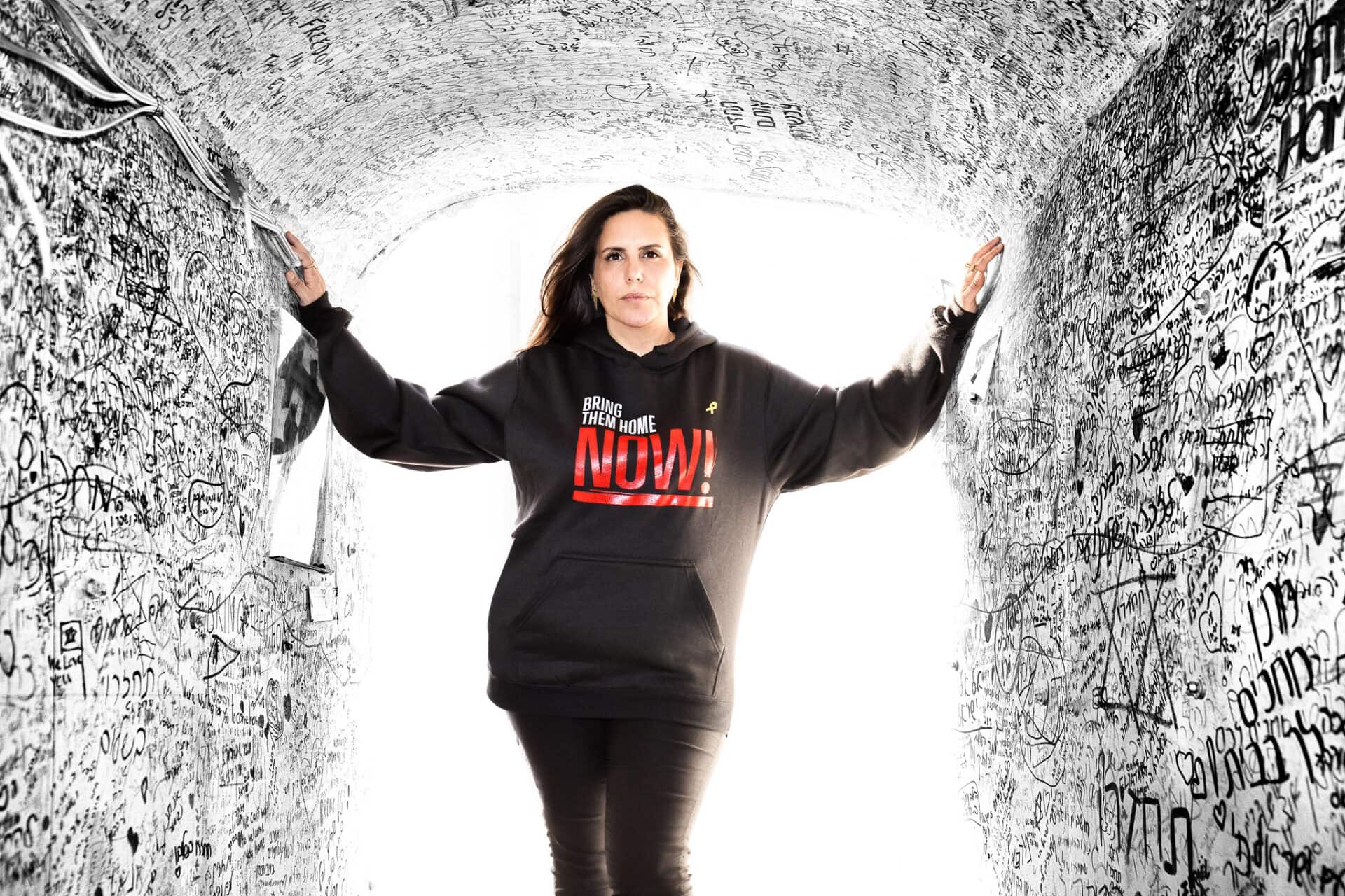 Ad executive Dorit Gvili in a replica tunnel built by artists and signed by visitors at Hostages Square in Tel Aviv. Photo by Noam Chen