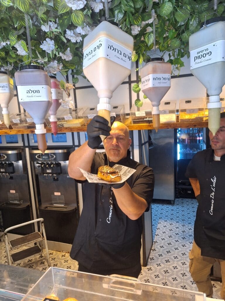 Tomer Levi creating a decadent ice-cream sandwich at Cremerie De L’éclair in Tel Aviv. Photo courtesy of Cremerie De L’éclair