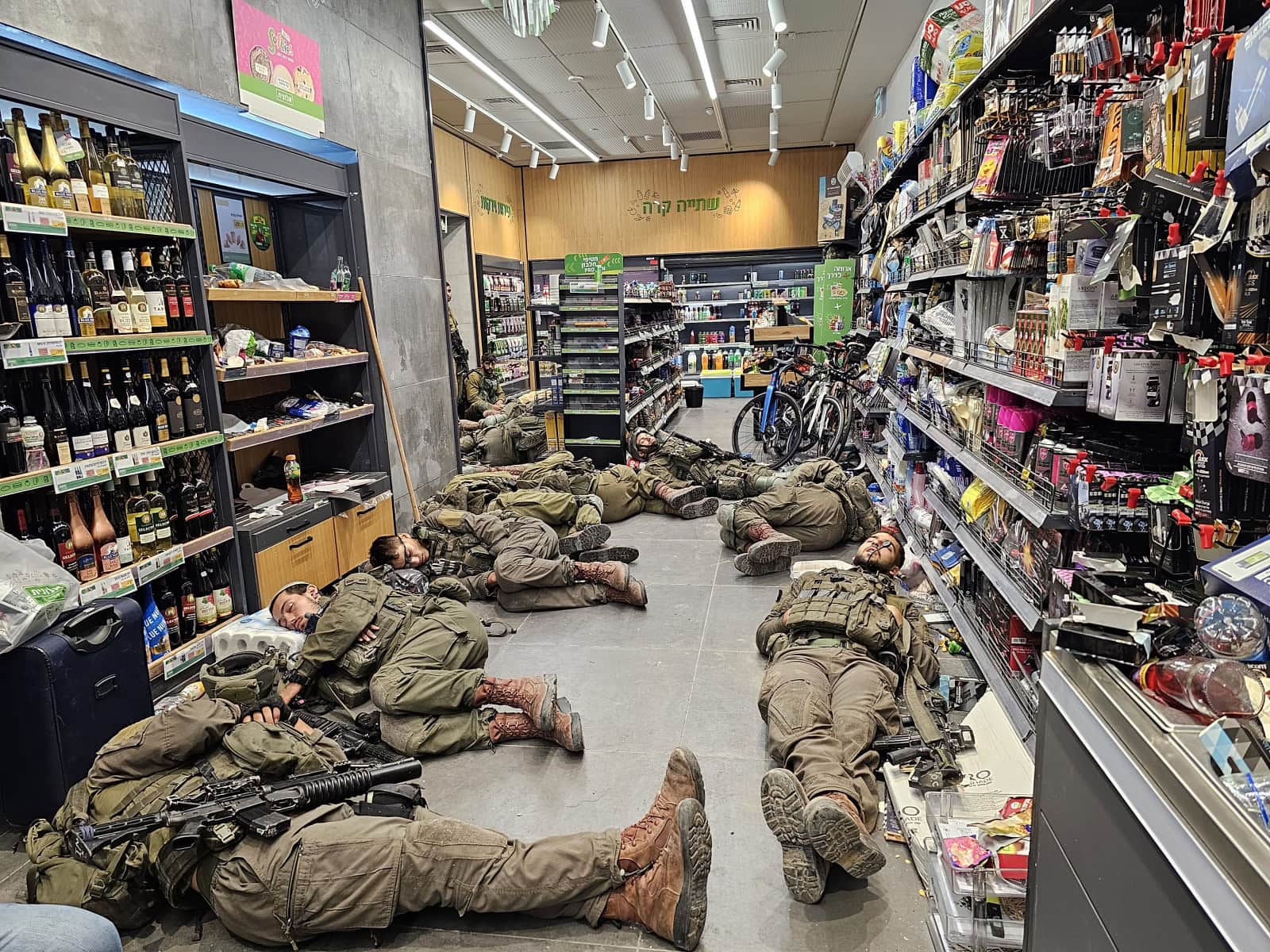 Soldiers resting at an Alonit gas station on the night between October 7 and October 8. Photo by Batia Holin, survivor of the massacre at Kibbutz Kfar Aza