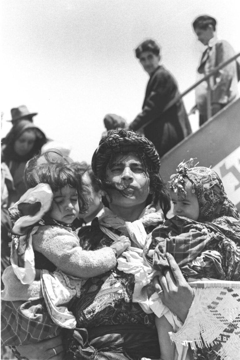 A mother and two children land from Iran at Lod Airport in Israel in 1951. Photo by Teddy Brauner/Government Press Office