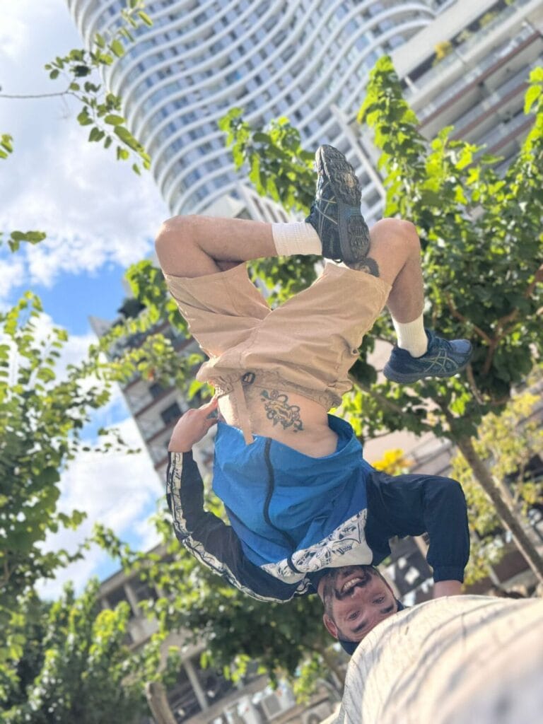 Bboy Poter performs a headstand on a railing. Photo courtesy of Yakov Krawec