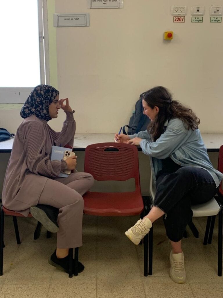 A Bedouin high school student and a BGU student during a Hebrew lesson. Photo courtesy of Malka Shacham
